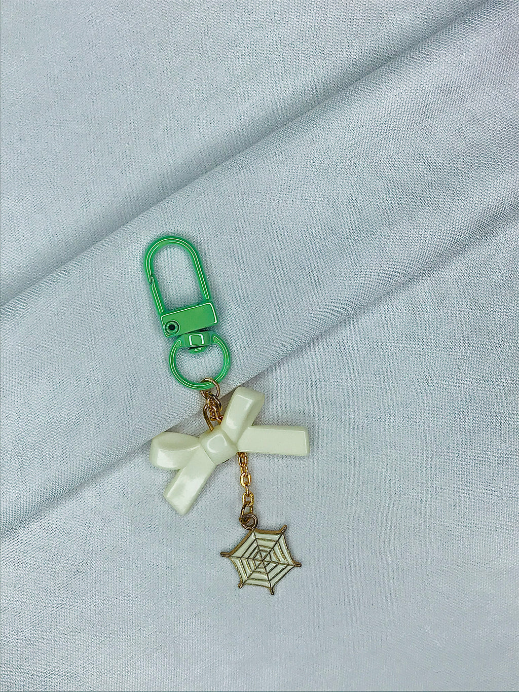 Webbed Whimsy Phone Charm | White Bow with Gold Spiderweb Pendant | Cute Aesthetic for Girls | Minimal Softcore Charm| green and White