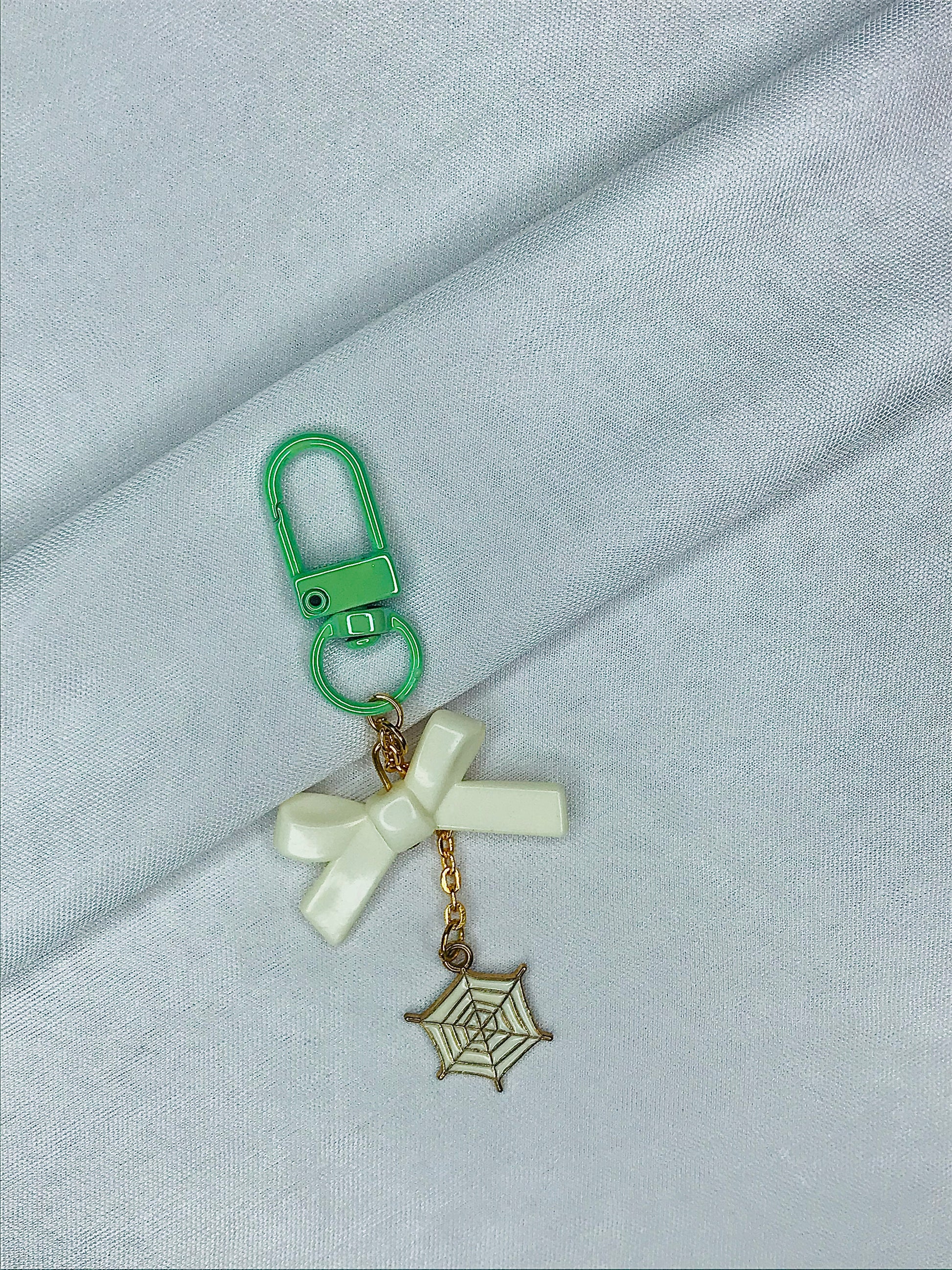 Webbed Whimsy Phone Charm | White Bow with Gold Spiderweb Pendant | Cute Aesthetic for Girls | Minimal Softcore Charm| green and White